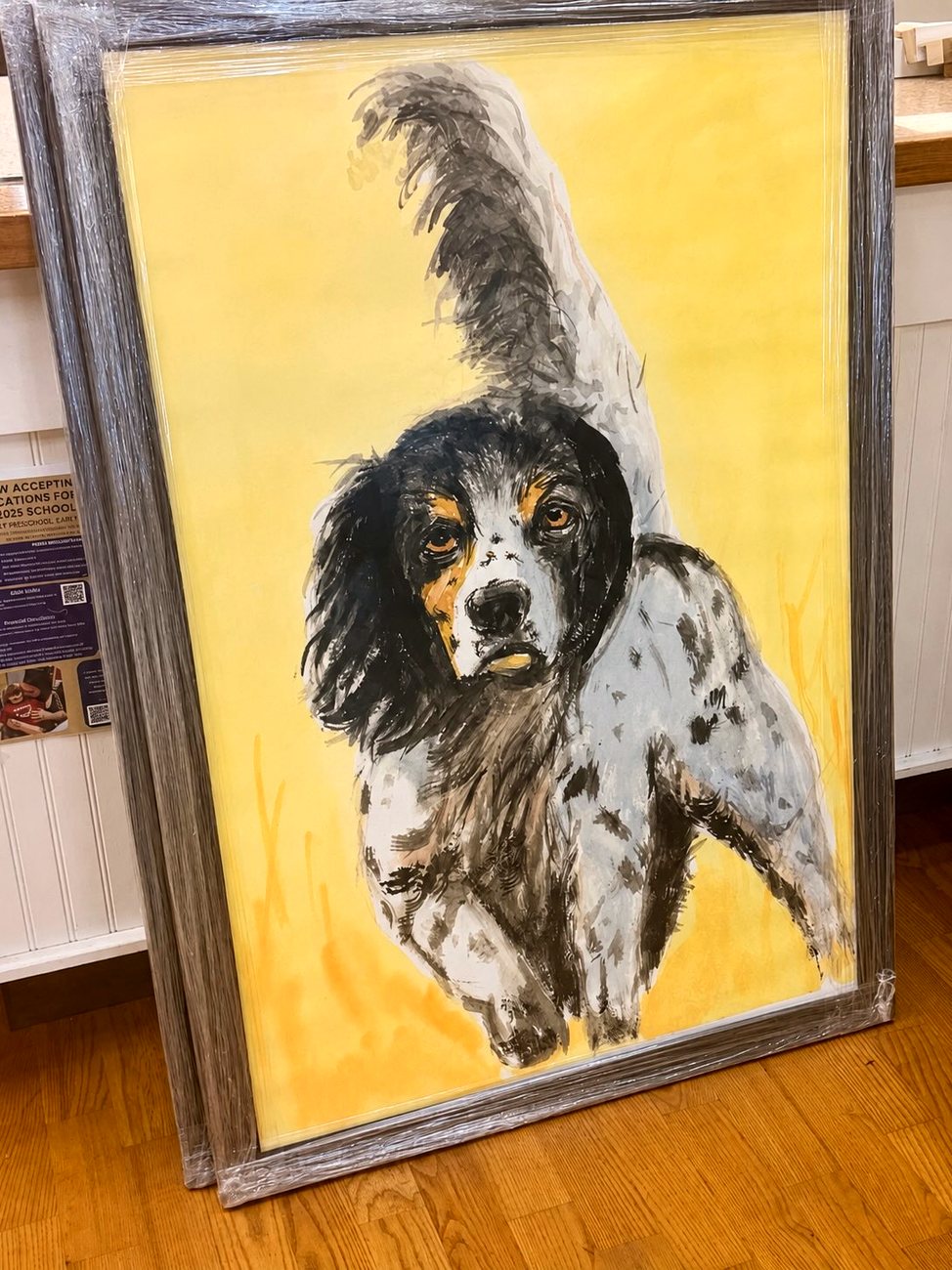 A framed sporting dog painting by Eddie Norris Jr, a spaniel on a yellow field