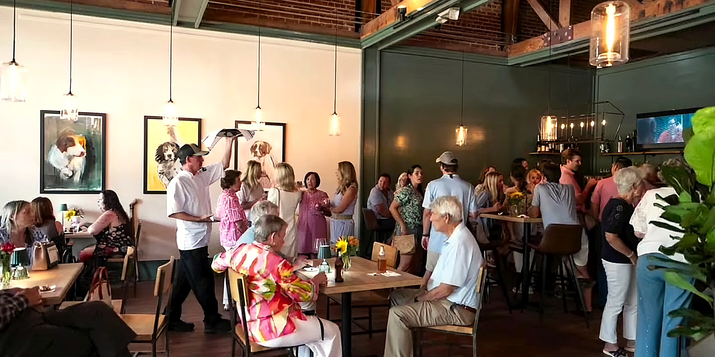 The room full for a private event under the timber trusses
