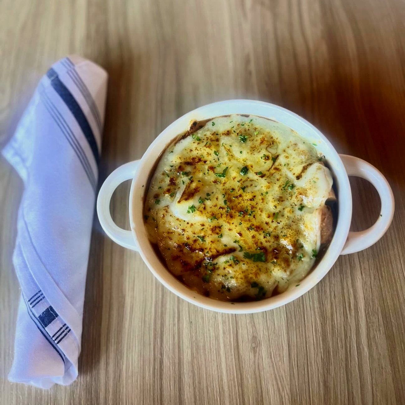 French onion soup under a browned cheese crust