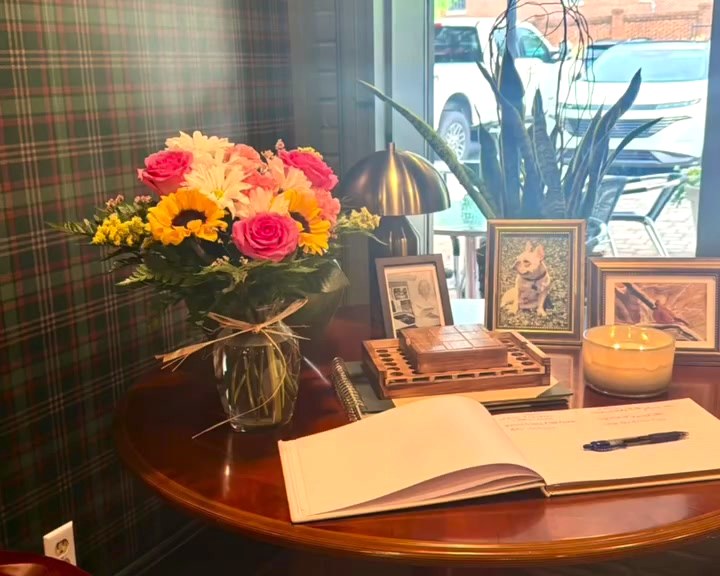The guest book and a jar of flowers by the window