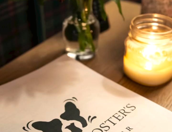 The card, a candle and a bud vase after dark