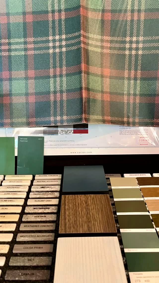 Wesley's material samples: her tartan hanging above a fan of wood and paint chips