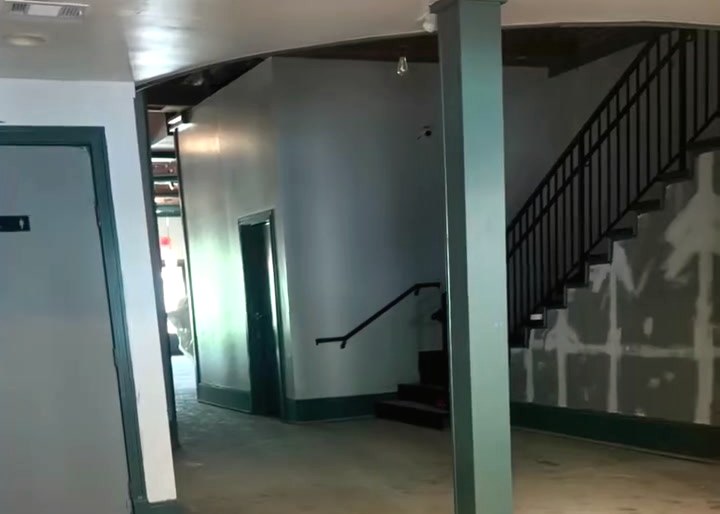 Downstairs stripped back to raw concrete during the build, the staircase bare