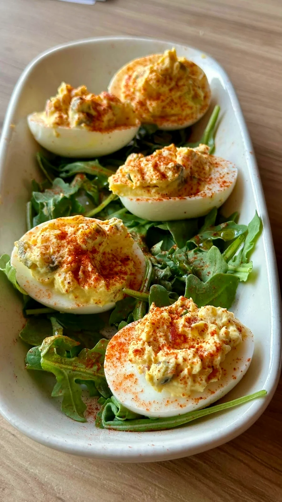 Deviled eggs, paprika and arugula